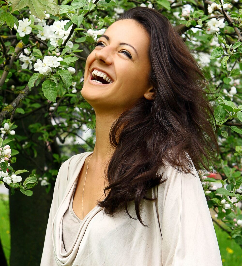 beautiful-woman-laughing-by-blossoming-tree (1) (1)