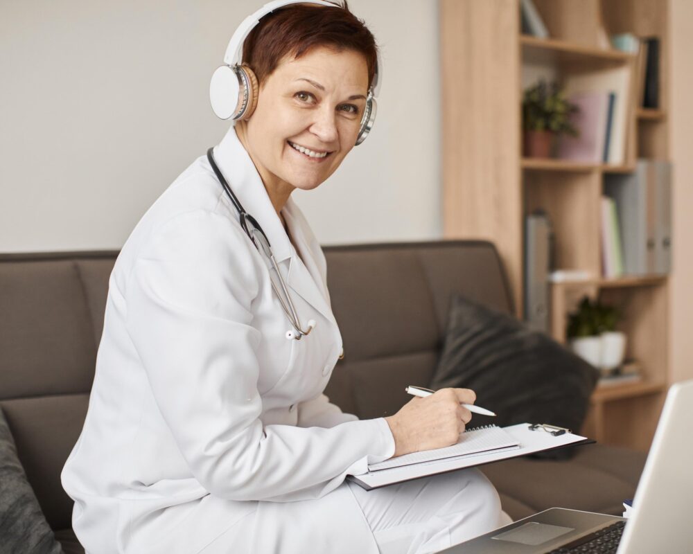 smiley-elder-covid-recovery-center-female-doctor-with-headphones-clipboard